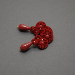 czerwone kolczyki lub klipsy sutasz