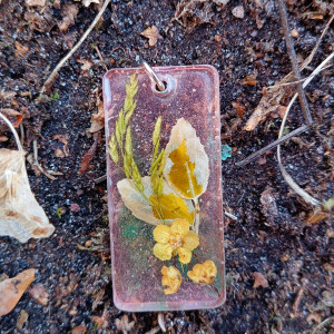 Bukiet kwiatów zamknięty w zawieszce z żywicy