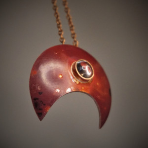 Moc, lunula miedziana z kryształem górskim.