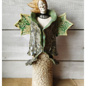 Anioł w płaszczyku  z rozwianymi włosami