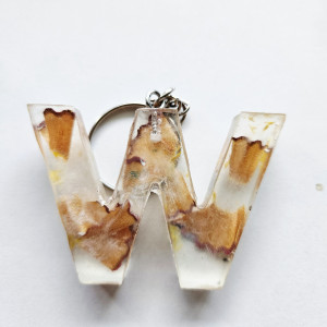 Brelok literka W przezroczysta z kredkami obierkami